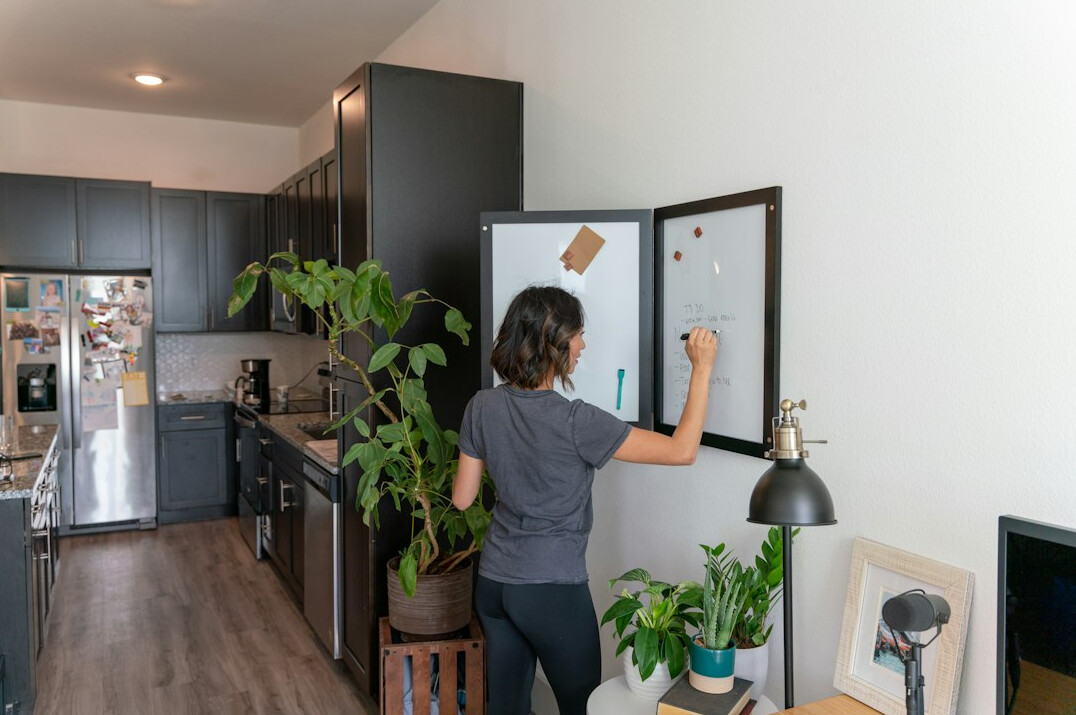 person tidying kitchen